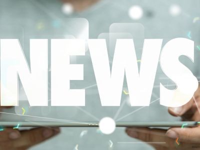 tablette numérique tenue par deux mains avec le mot news écrit au dessus