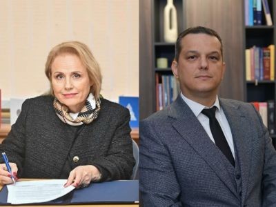 une femme assise derrière un bureau tenant une feuille et un homme